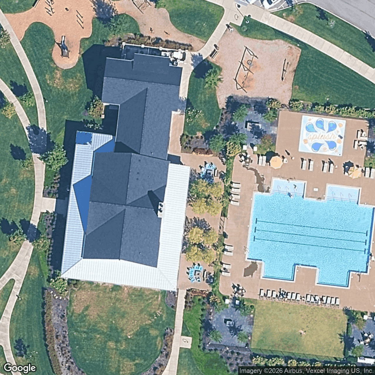 Aerial view of The Farmhouse amenity center at Durham Farms — resort pool, splash pad, and clubhouse