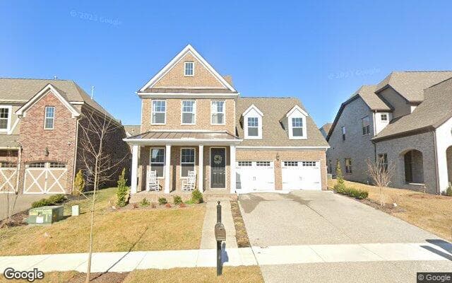 A two-story brick home with a covered porch in Millstone, Hendersonville