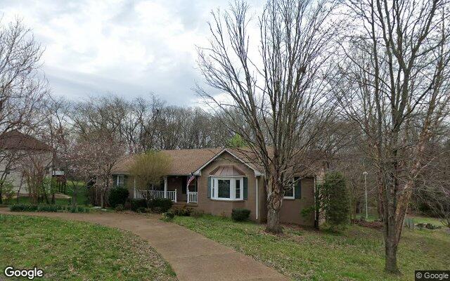 A ranch home under the trees in Indian Lake Forest.