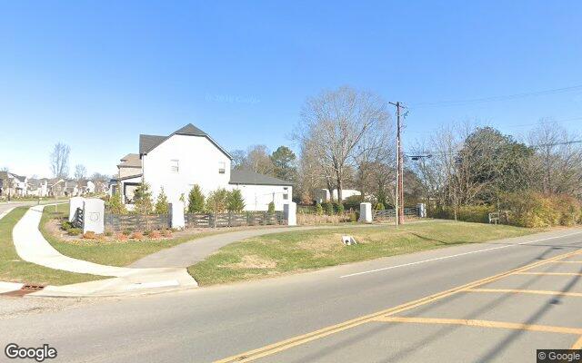 Entry landscaping, fencing, and a corner home at Laurel Park, Hendersonville