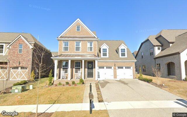 A two-story brick home with a covered porch in Millstone, Hendersonville